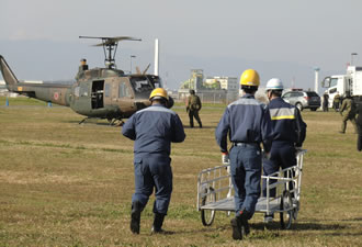 陸上自衛隊のヘリコプターで運搬された機器を受け取りに向かう訓練実施者